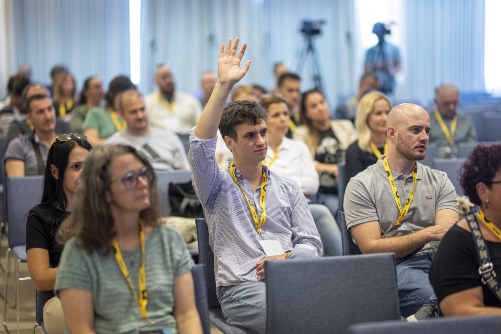 person raising a hand to ask something at mighty mainframe conference