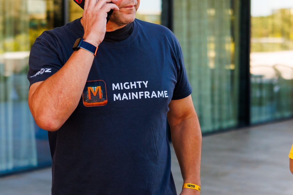 person in a mighty mainframe tshirt talking on a phone